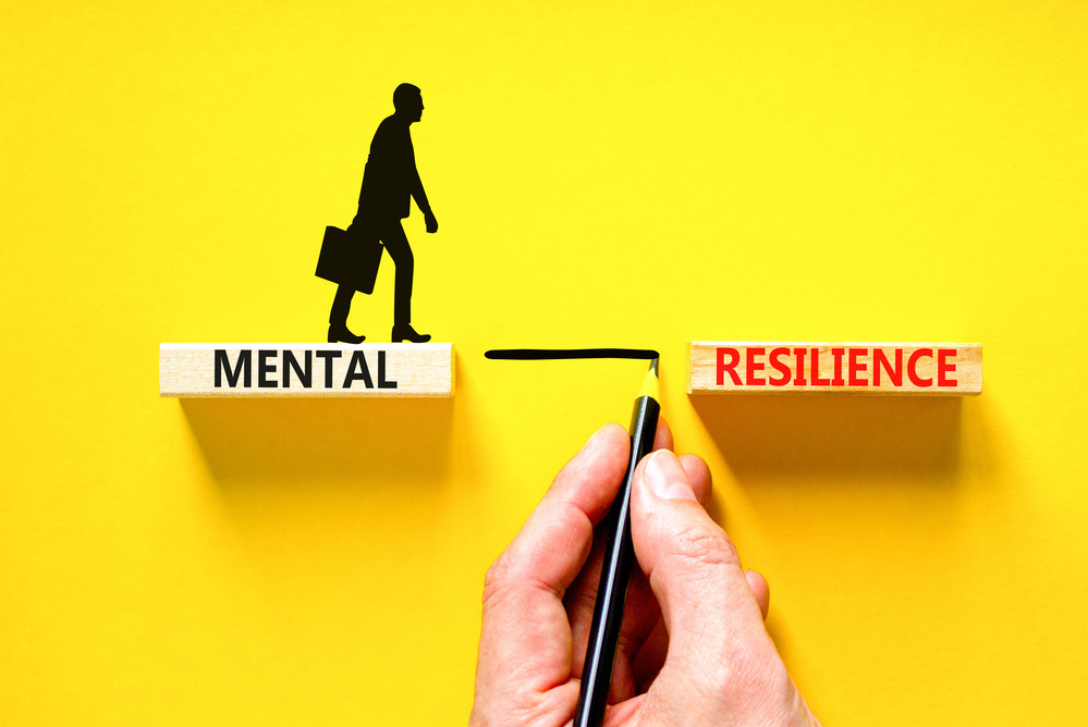 Mental resilience symbol. Concept word Mental resilience typed on wooden blocks. Beautiful yellow table yellow background. Doctor hand. Business psychological and mental resilience concept. Copy space