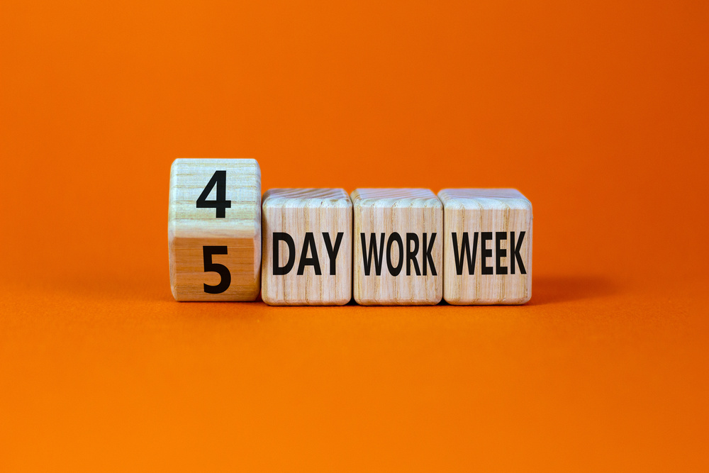 4 or 5 day work week symbol. Turned the cube and changed words '5 day work week' to '4 day work week'. Beautiful orange background. Copy space. Business and 4 or 5 day work week concept.