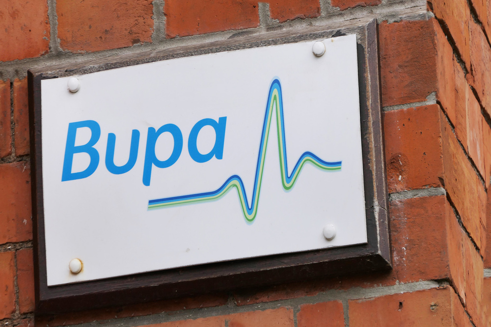 Bupa sign on a brick wall