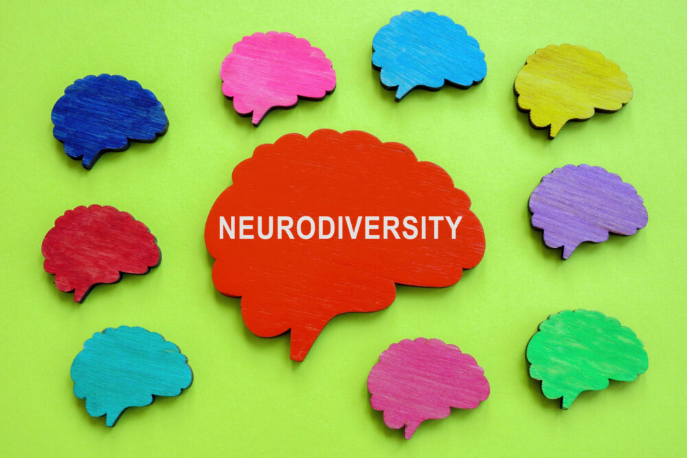 Colorful brains and one with sign Neurodiversity.