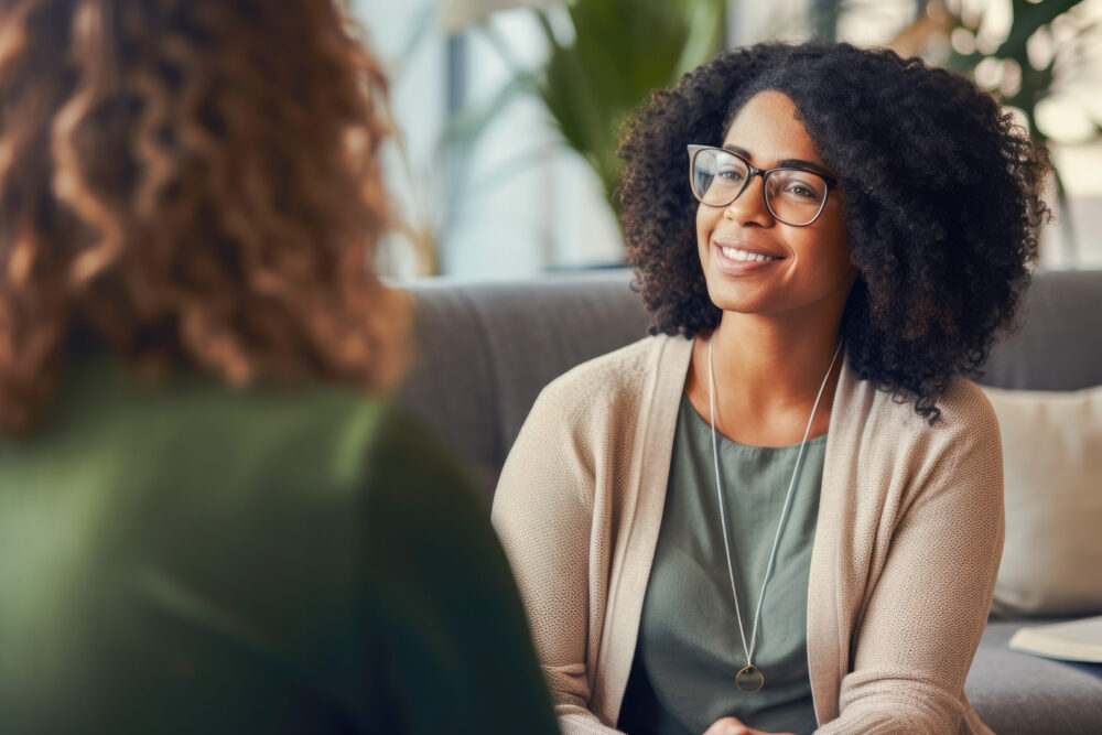 African American female counselor demonstrating empathy during a breakthrough session with a client, highlighting the importance of mental health support and therapeutic communication