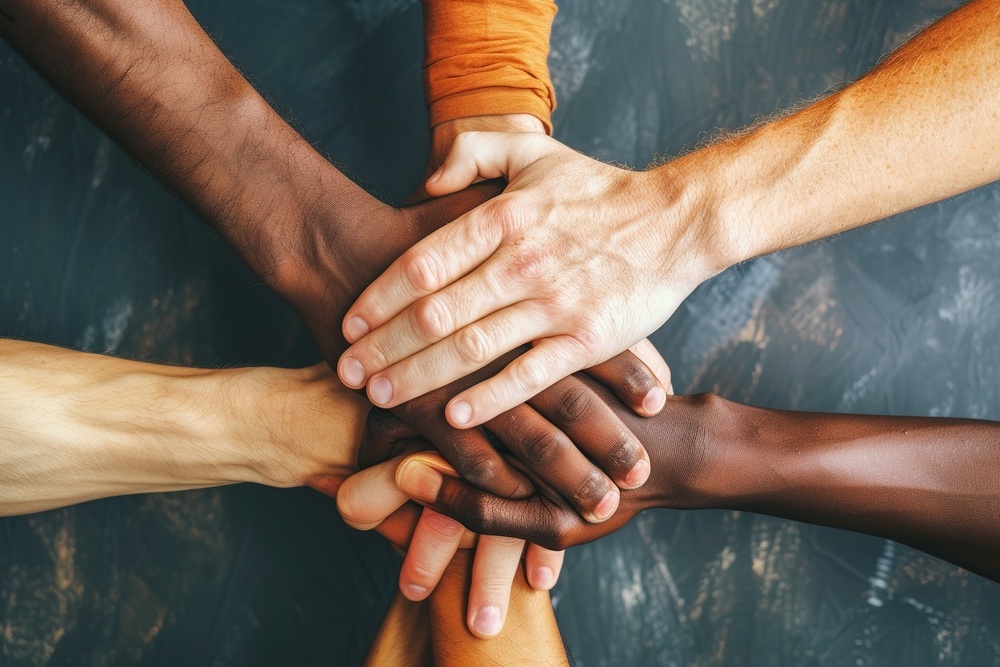 People of all colors holding hands, inclusive business mindset values dignity and respect for all individuals