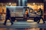 Workers loading a van at a warehouse during twilight