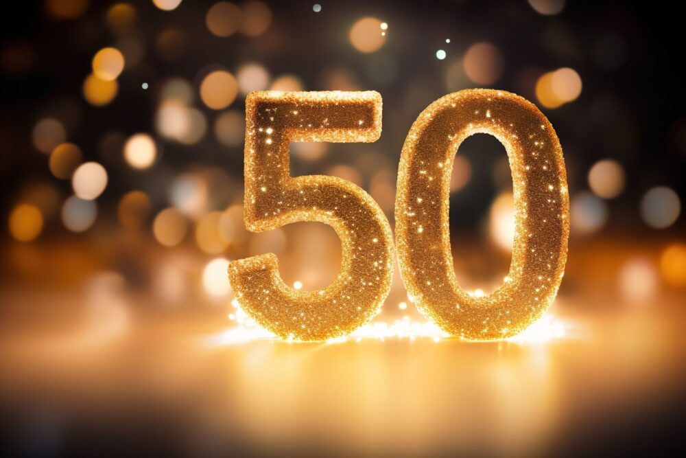 Golden sparkling number fifty on dark background with bokeh lights. Symbol 50. Invitation for a fiftieth birthday party or business anniversary.