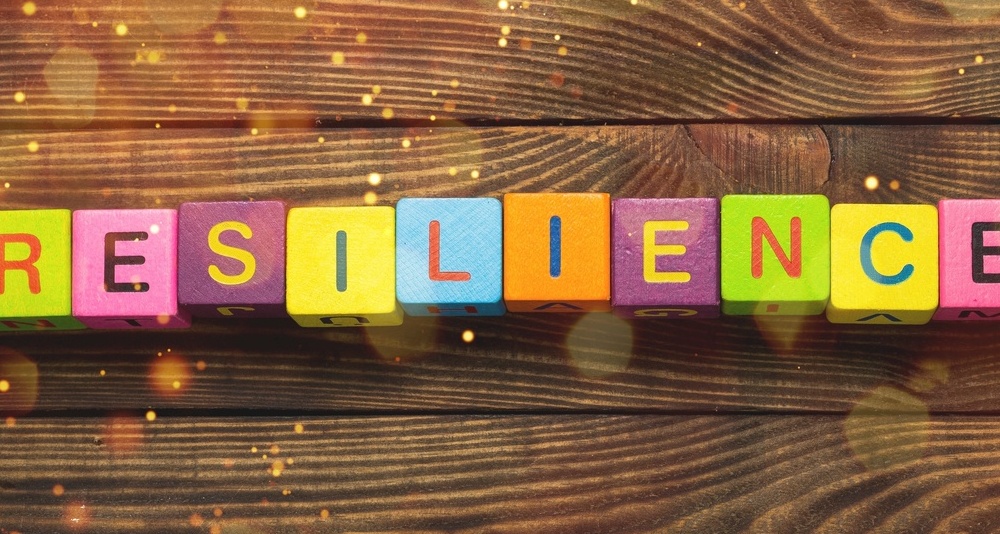 Resilience sign with wooden cubes on background