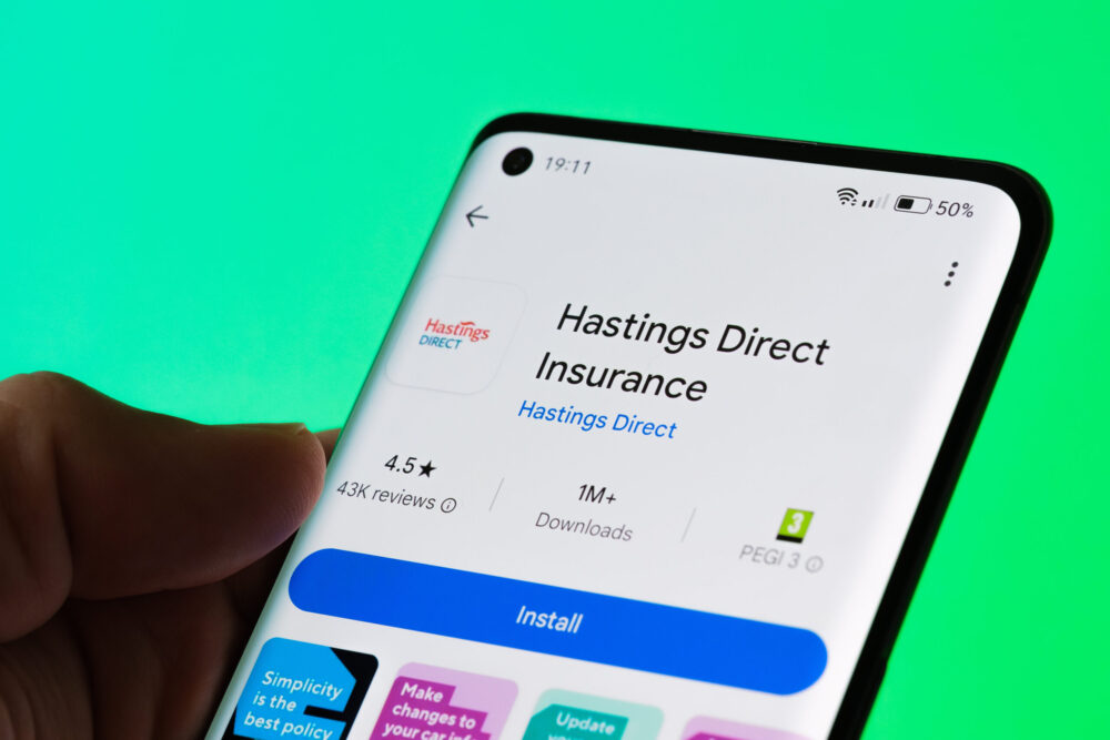 Hastings Direct Insurance app displaying on mobile phone with customer reviews, installation option, and latest features. Focus on mobile insurance management platform.