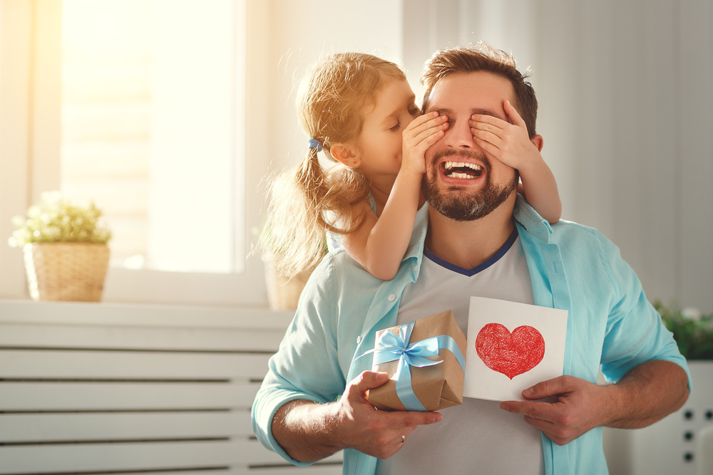 Father's day. Happy family daughter hugging dad and laughs