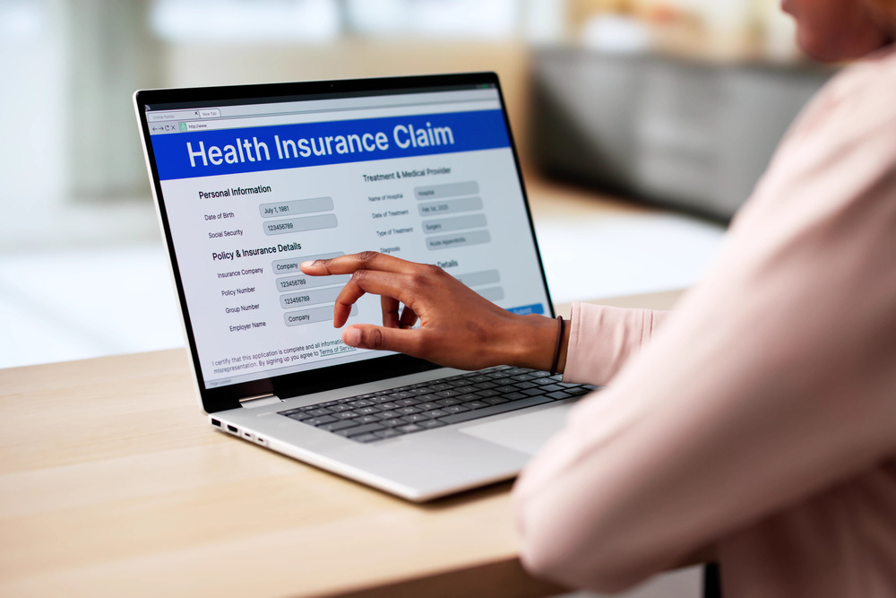 African American Woman Filling Blank Health Insurance Claim Form