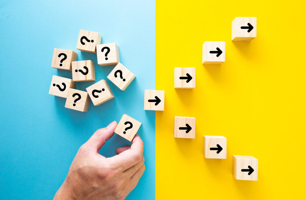 Hand choosing a block with question mark. ath leads to successfu