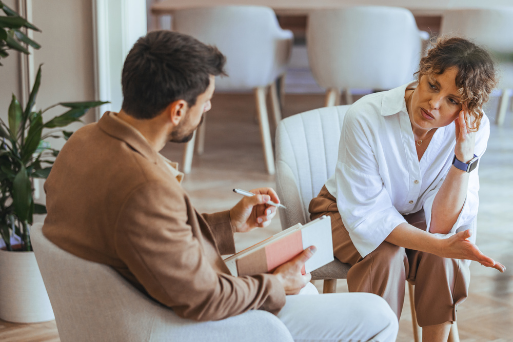 Professional Counseling Session Between Therapist and Client in Bright Office