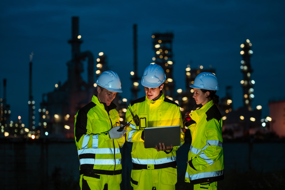 Diverse blue-collar workers collaborating on the job, highlighting engagement and workplace wellbeing