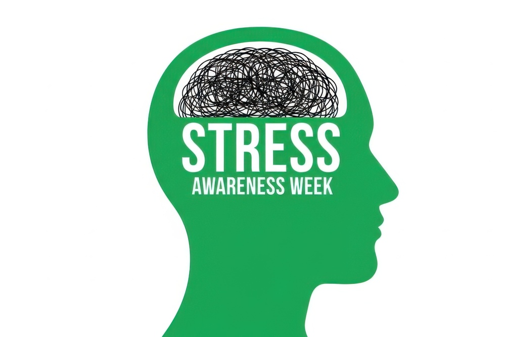 Stress Awareness Week banner with a human head profile and tangled lines inside the brain area. Green silhouette of a human head with a chaotic, black scribbled mess in place of the brain. Text: "STRESS AWARENESS WEEK". Graphic represents mental stress, anxiety, and the importance of mental health awareness, advocating for stress management and well-being.