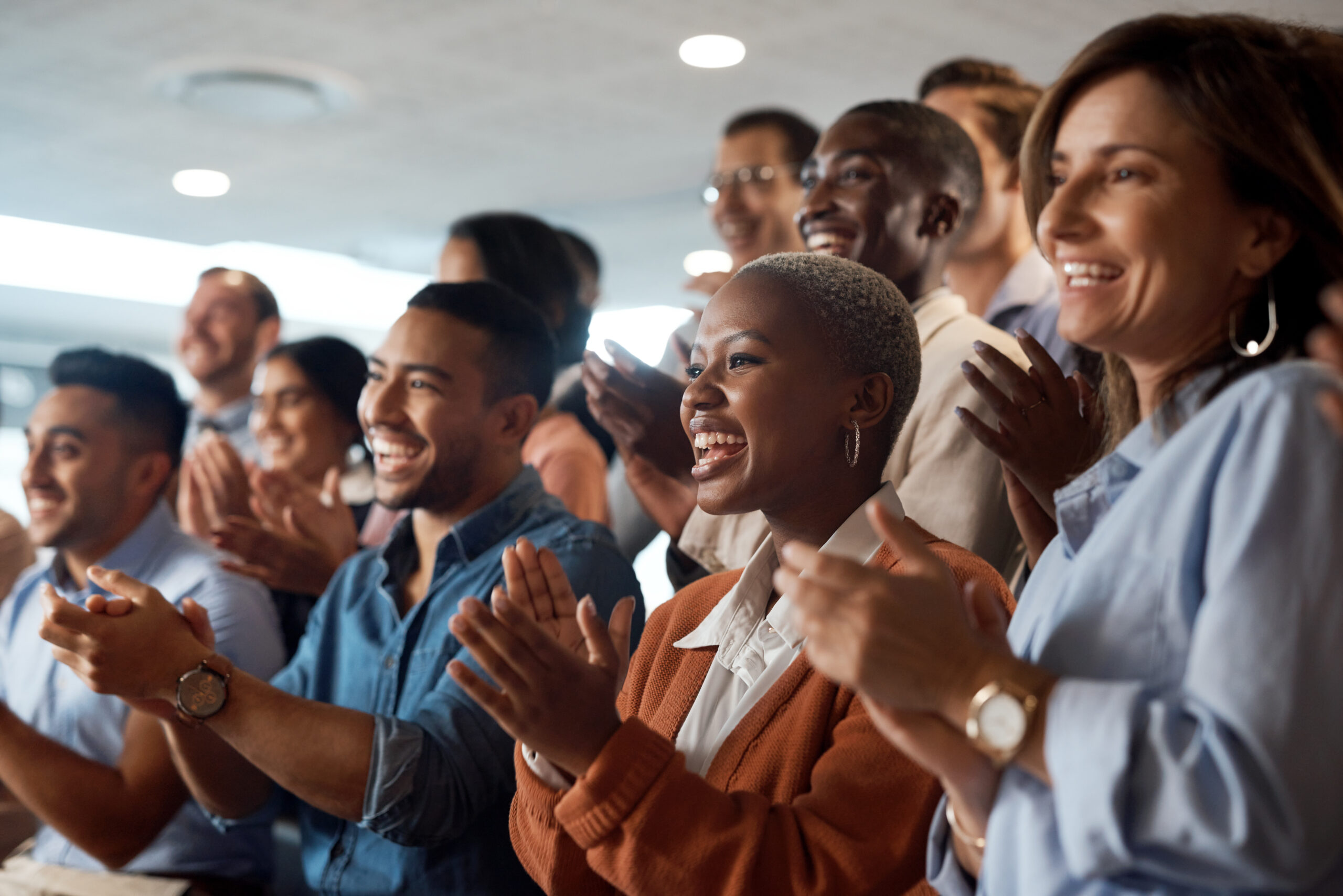 Applause, support and motivation with a business team clapping as an audience at a conference or seminar. Meeting, wow and award with a group of colleagues or employees cheering on an achievement.