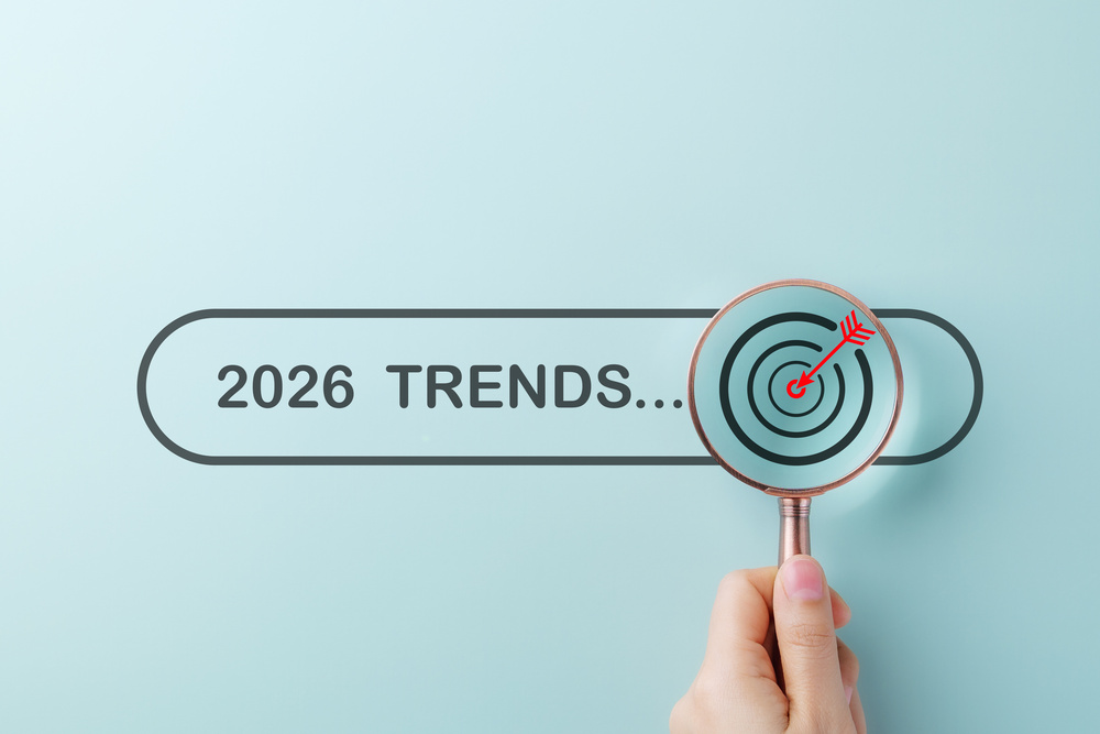Searching Business Trends for 2026. A hand holding magnifying glass over search bar 2026 Trends, symbolizing trend forecasting, marketing, new ideas, strategic plan in new year, business predictions,