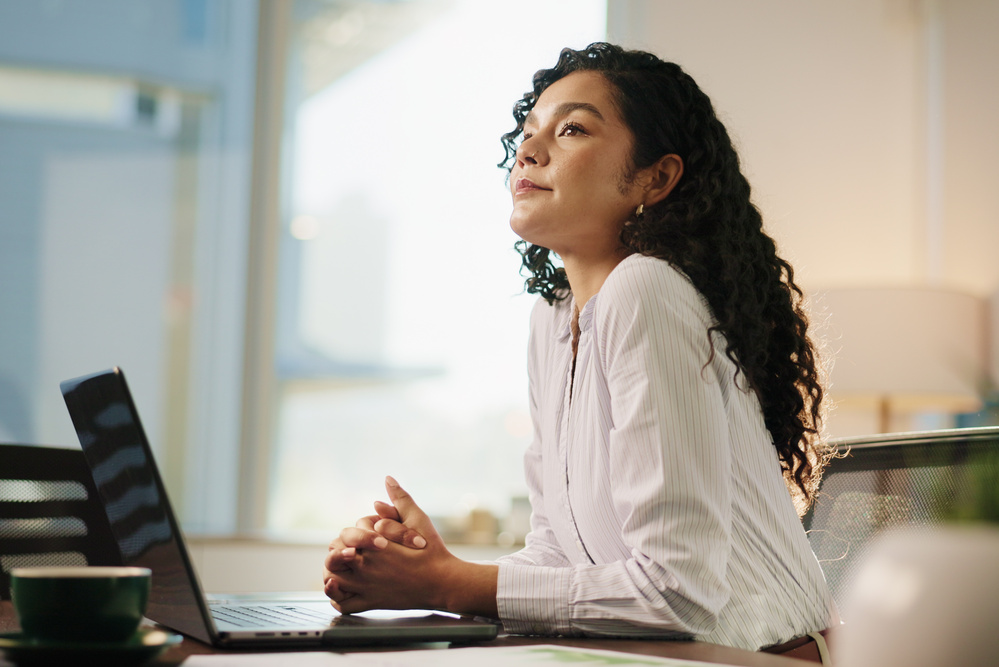 Business woman, thinking and laptop in office for legal research, case preparation or drafting will. Attorney, female person and advocate at law firm for court review, lawsuit idea or legislation.