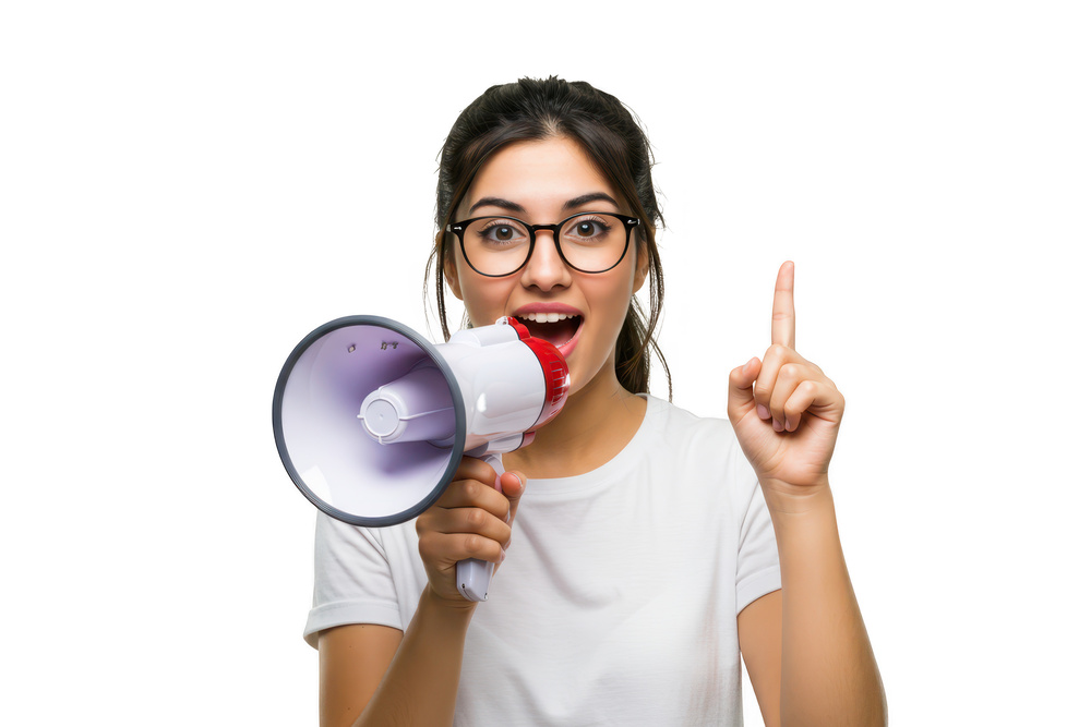 An excited woman with glasses holds a megaphone and points upwards, announcing an important message with enthusiasm, isolated on white isolated on transparent background