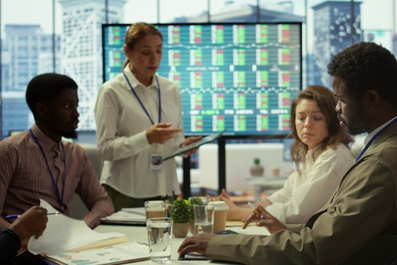 Senior executives seated around a boardroom table discussing workplace priorities and strategy for the year ahead