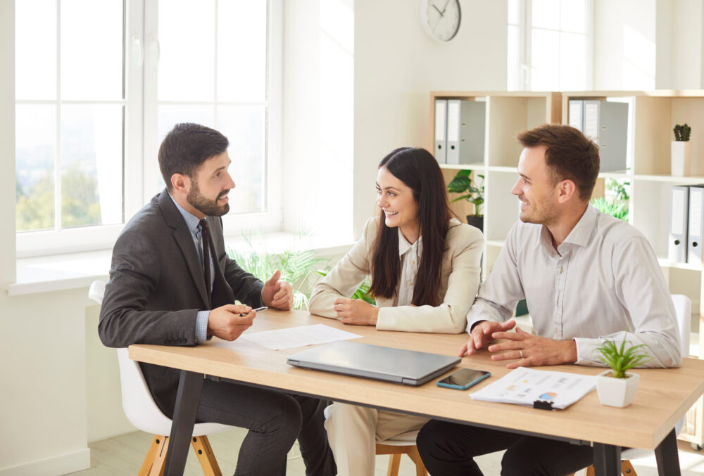 A manager giving constructive feedback to team members during a supportive performance conversation