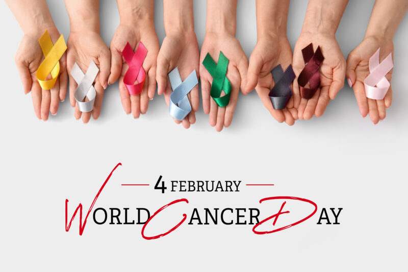 Hands holding different coloured cancer awareness ribbons to mark World Cancer Day on 4 February