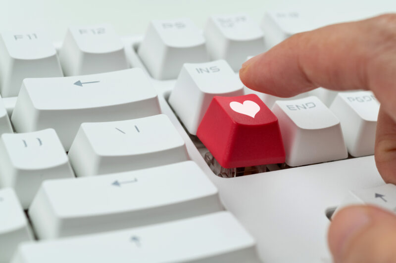 Keyboard with heart symbol button representing taking action to support heart health in the workplace