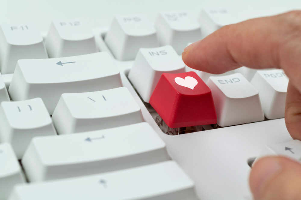 Keyboard with heart symbol button representing taking action to support heart health in the workplace