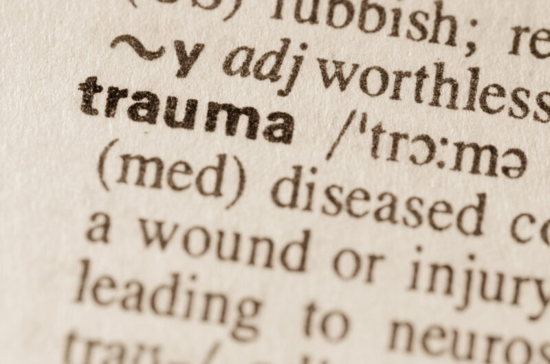The word “trauma” in a dictionary with its definition visible