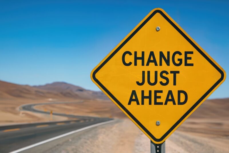 “Change ahead” road sign symbolising how organisations must support employee wellbeing through workplace change