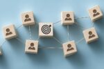 Bullseye target on interconnected blocks representing effective employee wellbeing and workplace culture communication