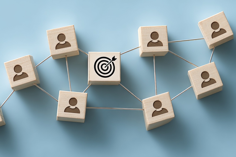 Bullseye target on interconnected blocks representing effective employee wellbeing and workplace culture communication