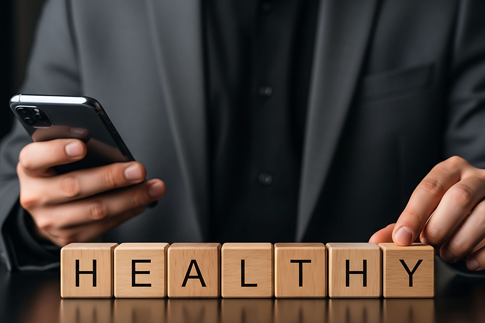 Professional using a mental health app on a smartphone in a workplace setting, representing digital wellbeing support tools