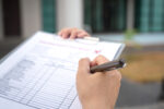 Professional at work with clip board an checklist to illustrate forthcoming HSE spot checks to ensure stress management requirements are being met.