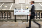 A man walking through Whitehall in London, symbolising UK government activity as ministers launch a new mental health strategy focused on prevention and early intervention.