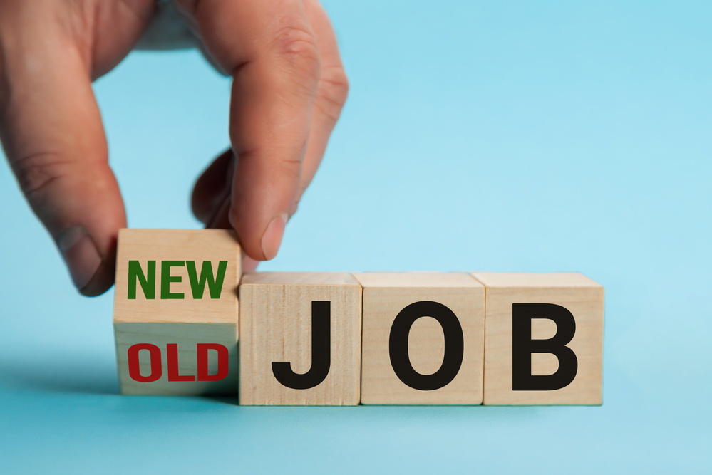 Old Job and New Job, Career change conceptual image. Hand is turning wooden cubes and changes the expression old job to new job.