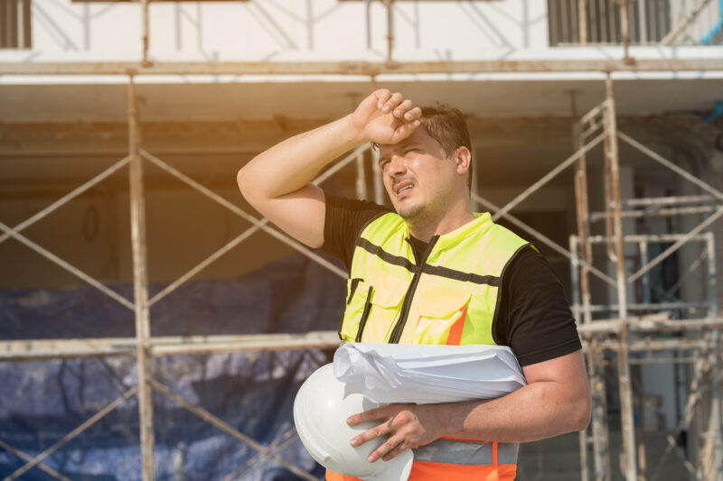 construction worker working in high temperatures and struggling as a result of the heat