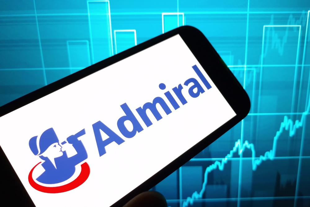Admiral Group logo displayed against a rising stock market chart, illustrating the growing link between workplace mental health, organisational performance and investor confidence.