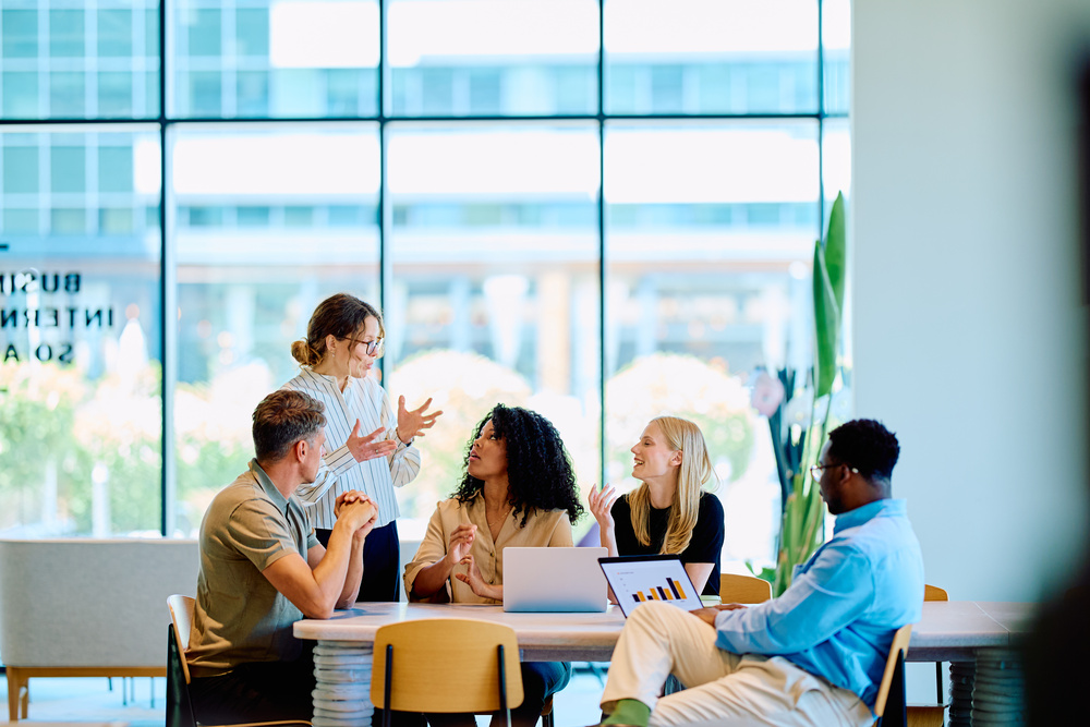 Business leaders discussing an integrated workplace wellbeing strategy