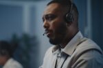 Call centre operator handling a difficult call and looking troubled