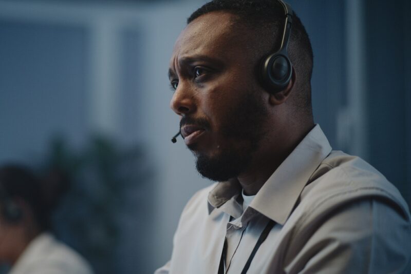 Call centre operator handling a difficult call and looking troubled