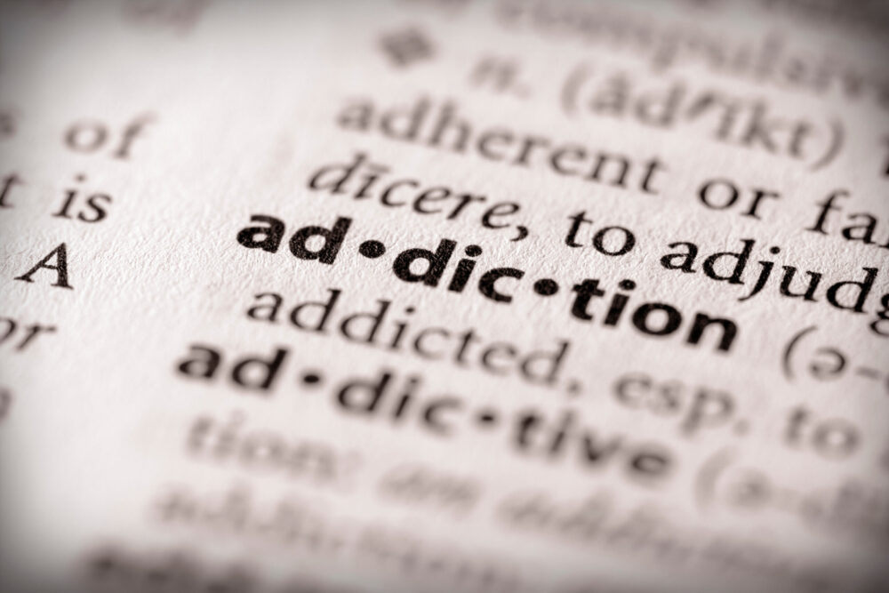 The word addiction in bold in a dictionary