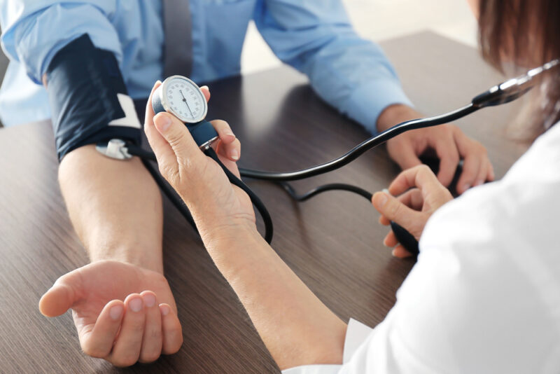 Health professional checking a person's blood pressure