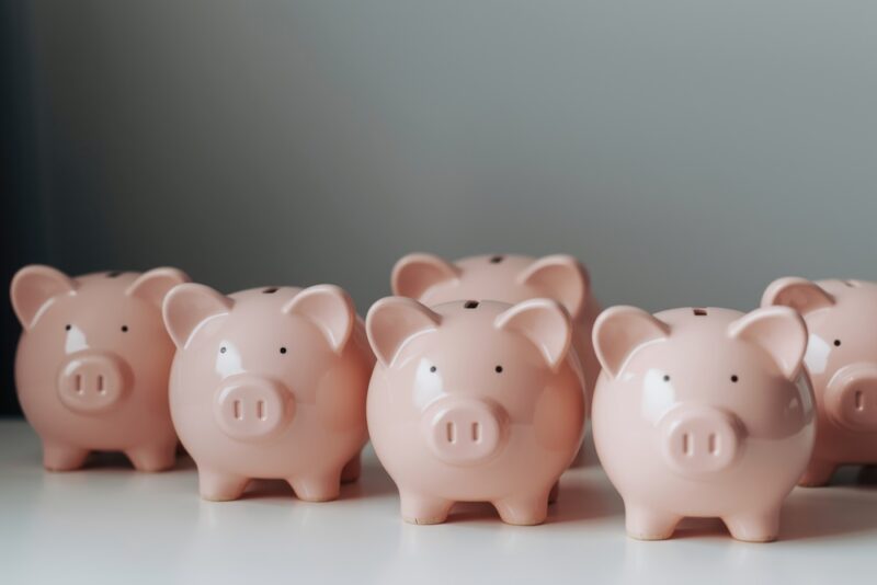 Group of pink china piggy banks representing workplace savings and financial wellbeing