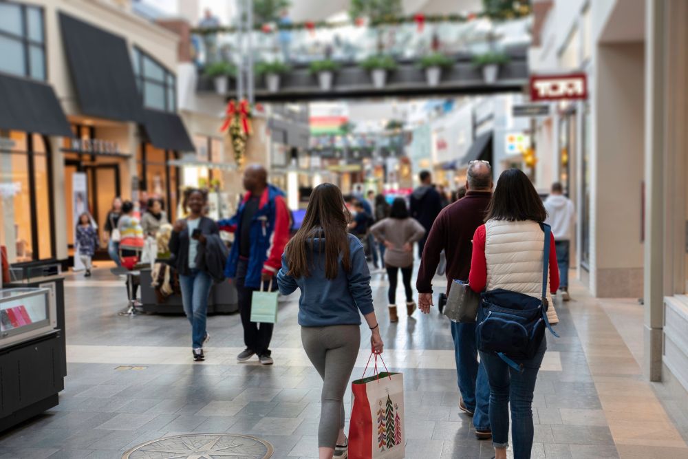 Shoppers walking through a busy shopping centre in the run-up to Christmas