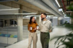 Colleagues walking and talking together in the workplace.Colleagues walking and talking together in the workplace.
