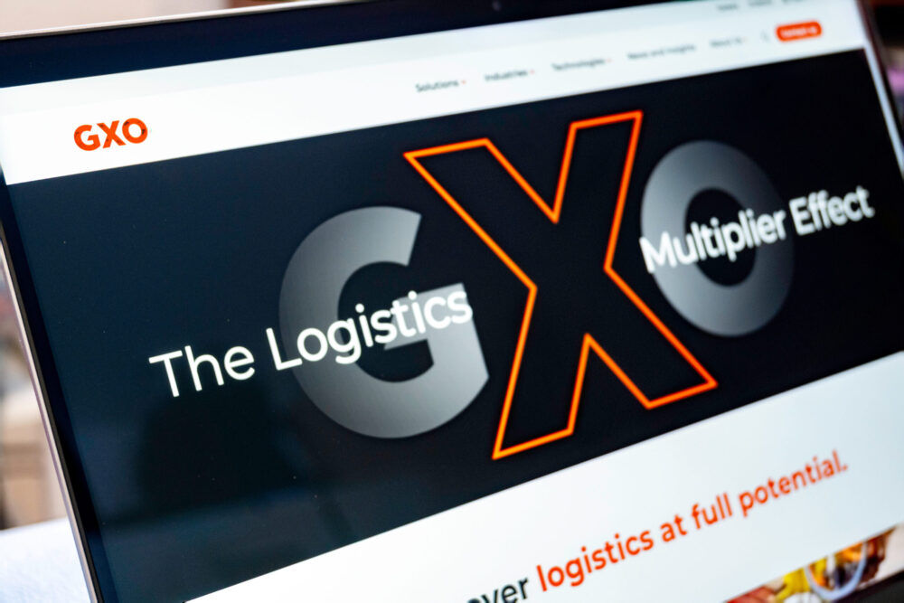GXO homepage showing the logo with the X standing out and the strap line "The logistics multiplier effect"
