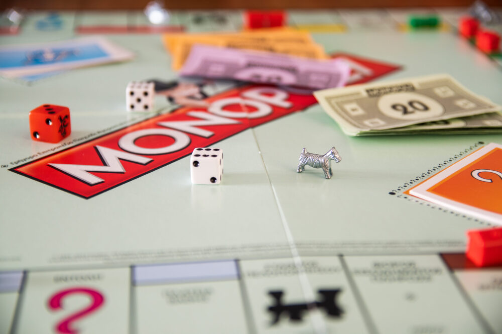 The monopoly board game with money and dice on the board